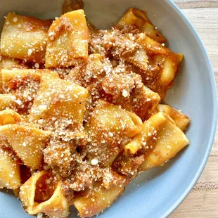 a bowl of pasta with meat and cheese