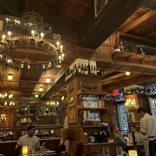 the interior of a restaurant with people sitting at tables