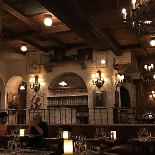 the interior of a restaurant with tables and chairs