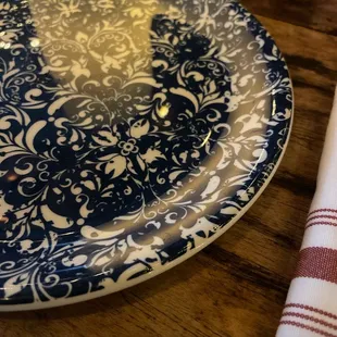a blue and white plate on a wooden table