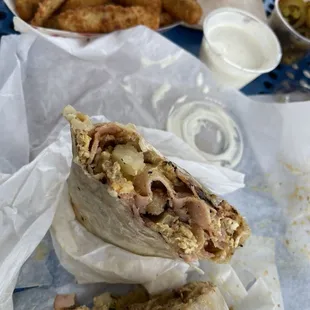 Breakfast burrito with ham, bacon, sausage, egg, potatoes &amp; zucchini fries