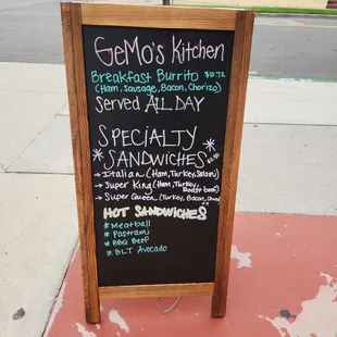 a menu on a sidewalk