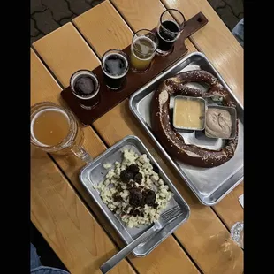 a tray of beer and a pretzel