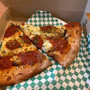 two slices of pizza in a box
