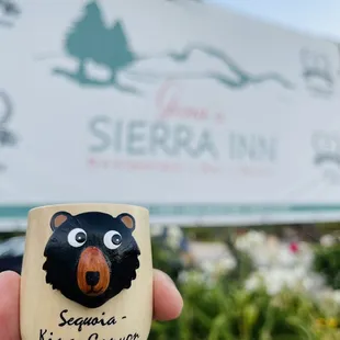 a hand holding a bear