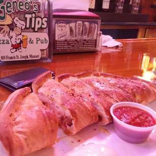 a plate of pizza and dipping sauce