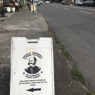 a sign on the sidewalk