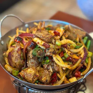 a bowl of food with meat and vegetables