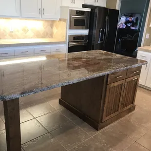 The island includes a motorized trash cans including recycle bin built into the island