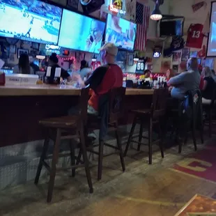 People at the bar at Generations Grill and Sports Bar watching TV