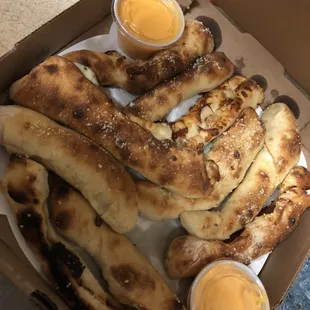 a box of bread and dipping sauces