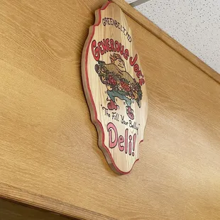 Sign above kitchen and ordering area. Made by local artist.