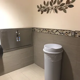 Clean restroom with changing station.