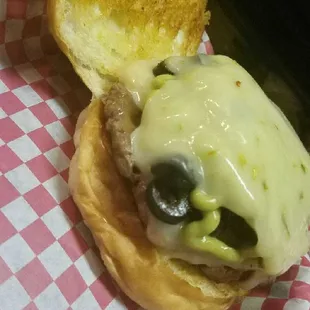 a cheeseburger with pickles
