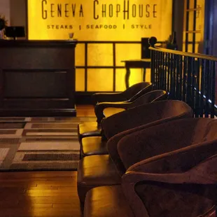 a row of chairs in front of a counter