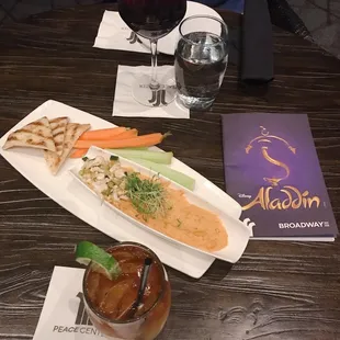 a glass of wine and a plate of food