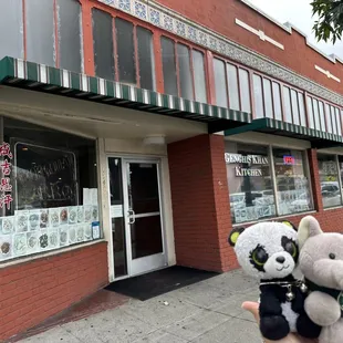 a person holding two stuffed animals