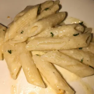 shows a plate of pasta with cheese and parsley