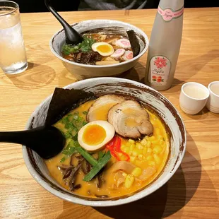 two bowls of ramen and a glass of water