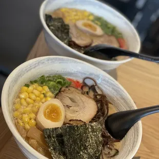 two bowls of ramen and a spoon