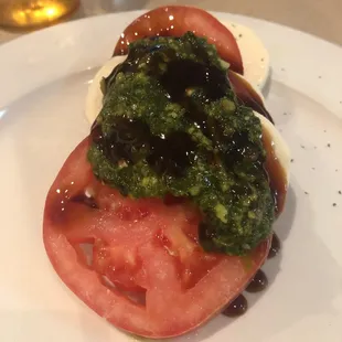 Caprese salad topped with pesto and an aged balsamic