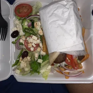 a salad in a styrofoam container