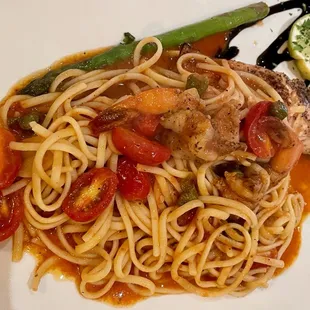 Salmone Romano $18. Pan-broiled salmon w/ sautéed shrimp, tomato, asparagus, capers, EVOO garlic sauce, linguine