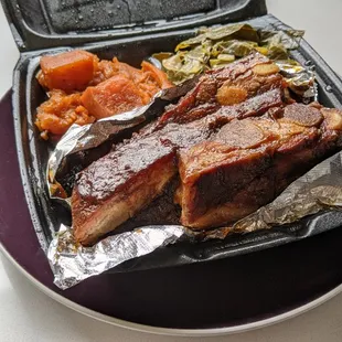 Ribs, greens, and REALLY sweet candied yams. There were so many ribs, the lid couldn&apos;t close