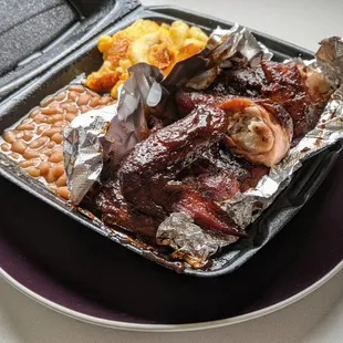 Barbecued chicken, beans, and mac and cheese.
