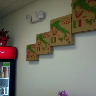 pizza boxes on the wall