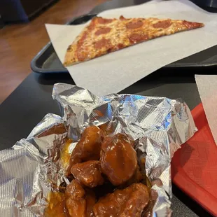 Hot BBQ boneless wings and a slice for lunch, fresh and hot