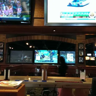 a bar with multiple televisions
