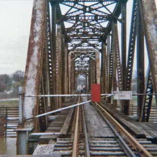 a man walking across a bridge