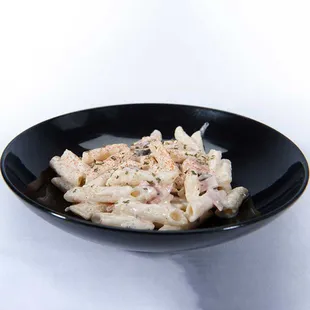 Penne pasta salad with ham, pepperoni, and black olives from the Genova's To Go menu.