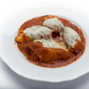 Genova&apos;s To Go four stuffed shells topped with melted mozzarella cheese and homemade tomato sauce.