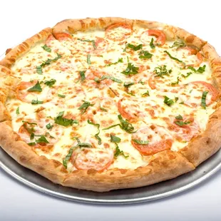 Tomato basil pizza from Genova&apos;s To Go, topped with cheese and tomatoes on a white surface.