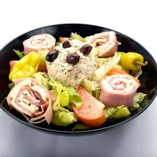 A delightful bowl of Chef salad Genova&apos;s To Go, filled with mouthwatering meat, cheese, and vibrant veggies.