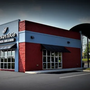 A vibrant red and blue building with a sleek black awning, home to Genova&apos;s To Go in Hanover, PA.