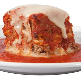 A Genova&apos;s To Go savory meatloaf topped with melted mozzarella served on a white plate surrounded by our original tomato sauce.