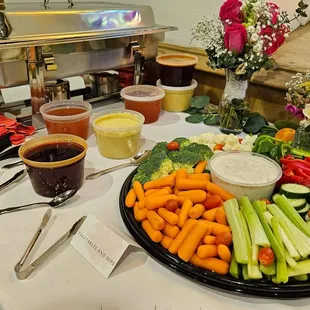 a platter of vegetables and dips