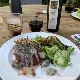 a plate of food and a bottle of wine