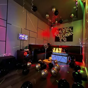 a room with balloons and lights