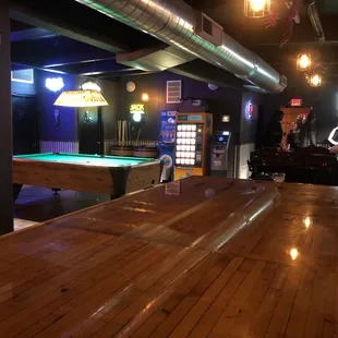 3 pool tables in the distance towards the back