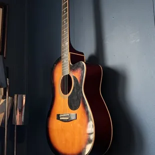 a guitar hanging on a wall