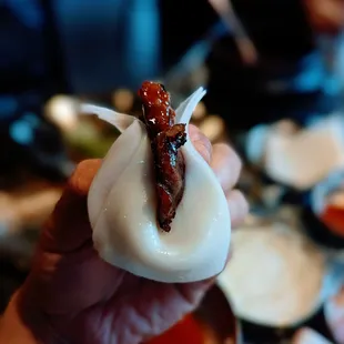 a person holding a piece of food