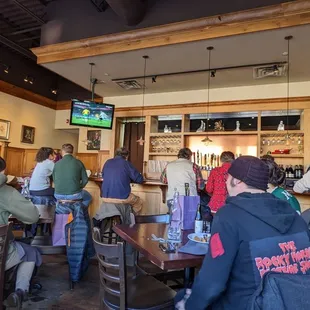 a group of people sitting at a bar