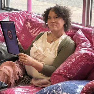 a woman sitting on a couch with a laptop
