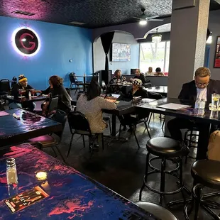 people sitting at tables in a restaurant
