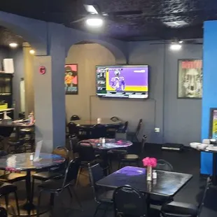 the interior of a restaurant with tables and chairs