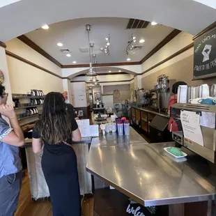 a man and a woman standing at the counter